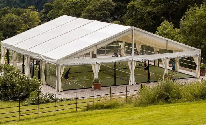 Padel court tent interior showing column-free space and court layout with glass fencing