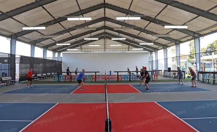 Retractable pickleball tent structure showing aluminum frame assembly and modular construction