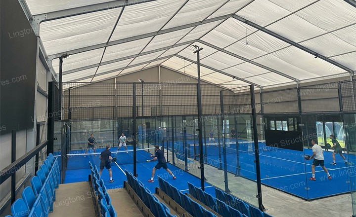 Padel court tent with transparent side walls allowing natural daylight for indoor play