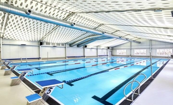 5601788762931484.jpg Swimming pool tent interior showing column-free space with transparent side walls allowing natural daylight