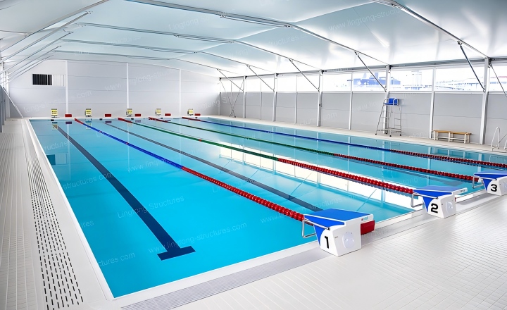 Swimming pool tent interior showing the pool deck and filtration equipment